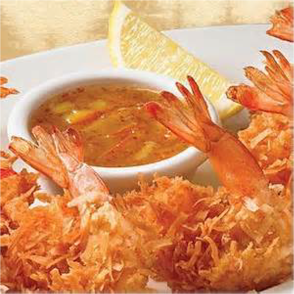 Coconut shrimp on a dish with sauce and a lemon wedge