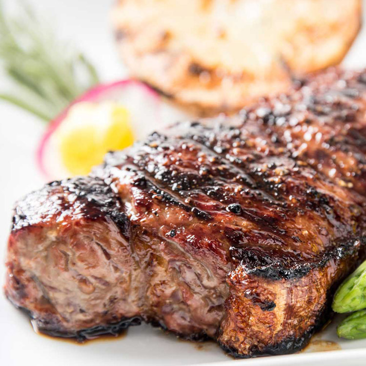 10 oz center cut char grilled NY Strip steak topped with a garlic herb compound butter.