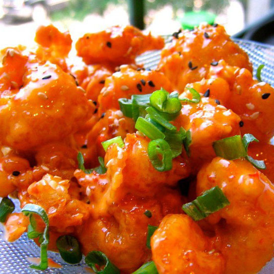 A half pound of fried shrimp piled high with spicy Thai sauce and topped with scallions, crispy wontons, and sesame seeds.