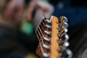 A person playing guitar. RJ’s On the Lake is full-service restaurant located on beautiful Sand Lake with award-winning pizza.