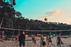 Group of people playing beach volleyball. RJ’s On the Lake is full-service restaurant located on beautiful Sand Lake with award-winning pizza.