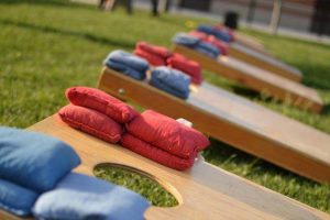 A corn hole or bags board with red and blue bags on top. RJ’s On the Lake is full-service restaurant located on beautiful Sand Lake with award-winning pizza.